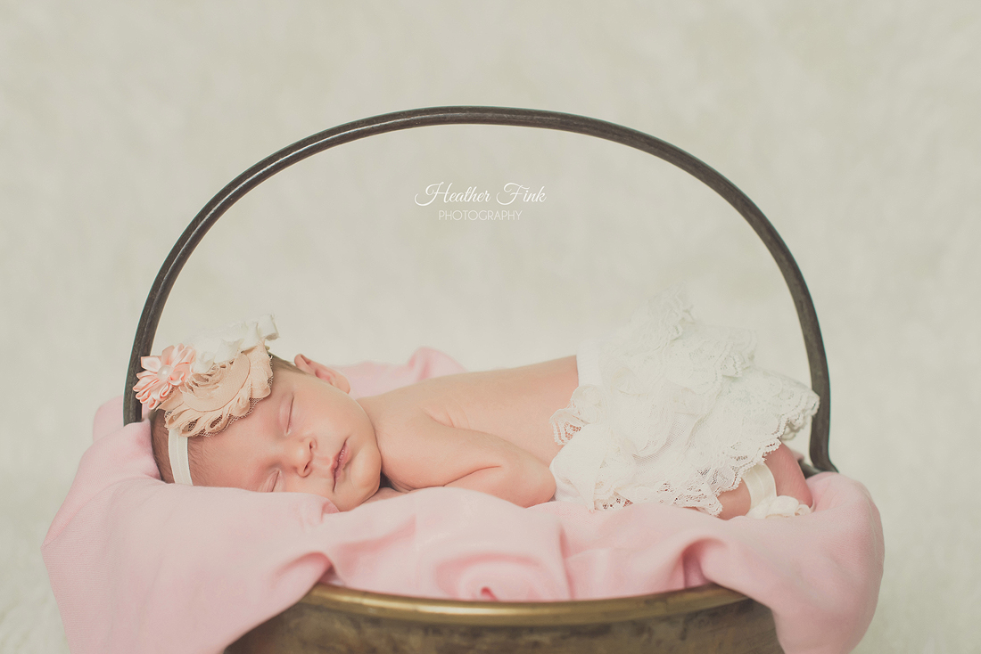 newborn girl sleeping pretty in pink