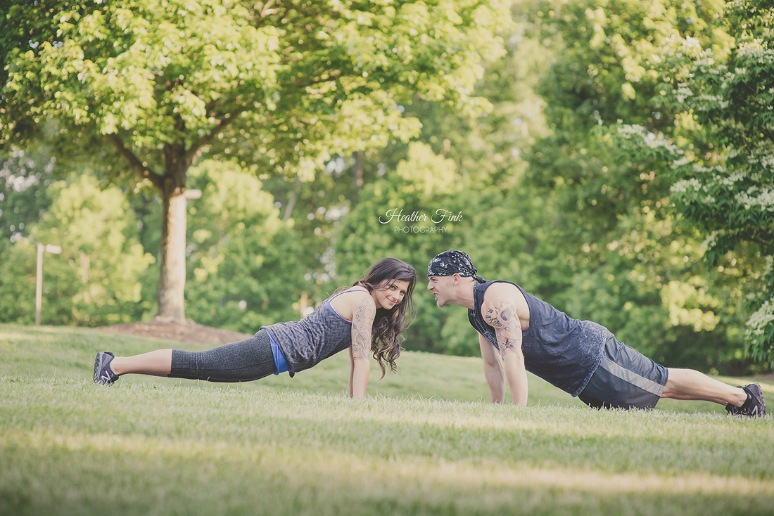 couple doing push ups during engagement session