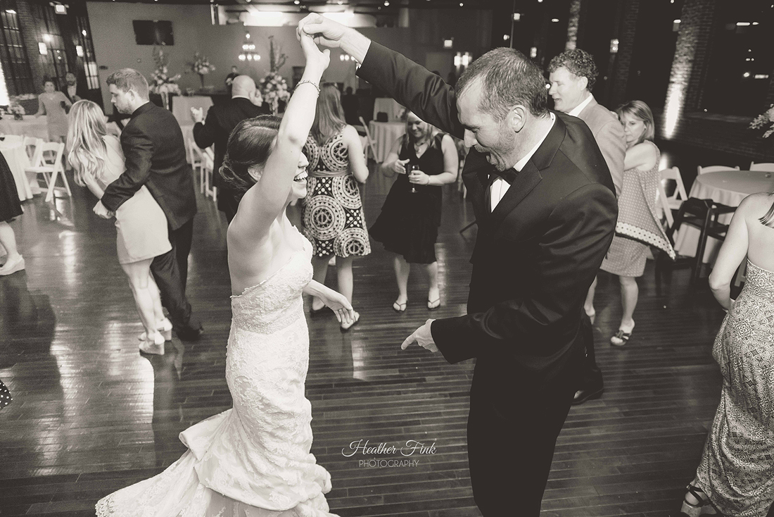 groom swirls bride on dance floor