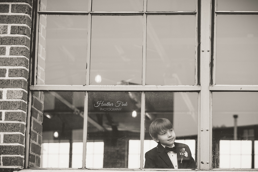 little boy glances out window at reception