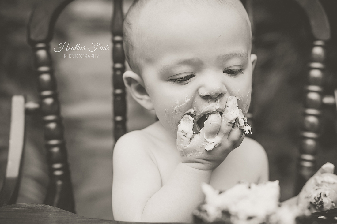 one year old boy eats cake at charlotte photography smash cake session